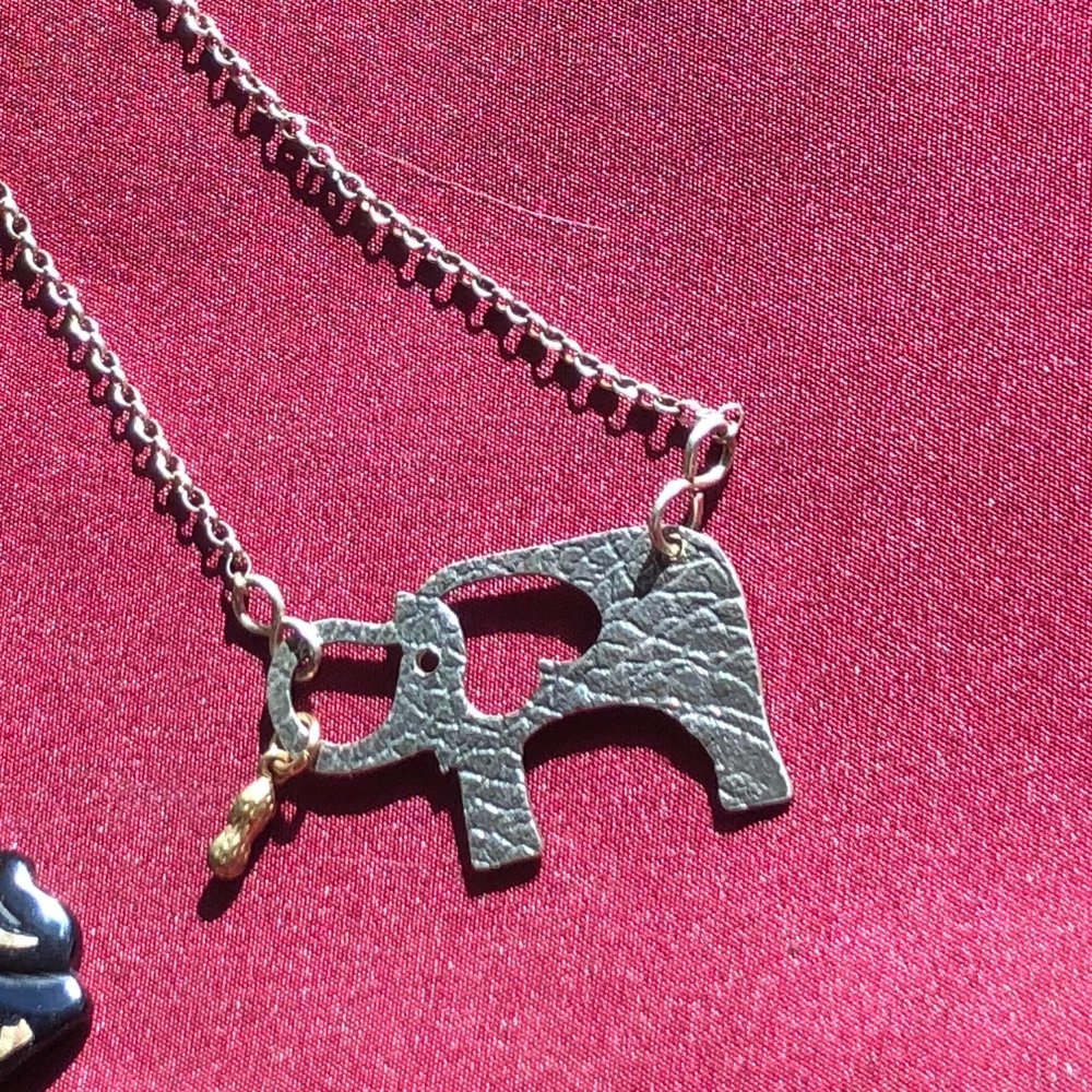 Never worn Thin delicate metal elephant and peanut treat necklace